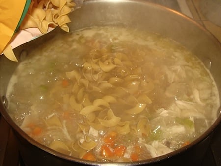 adding noodles to soup