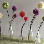 pom flowers in bottles